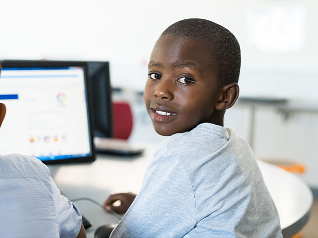 male african-american child looking over shoulder and smiling
