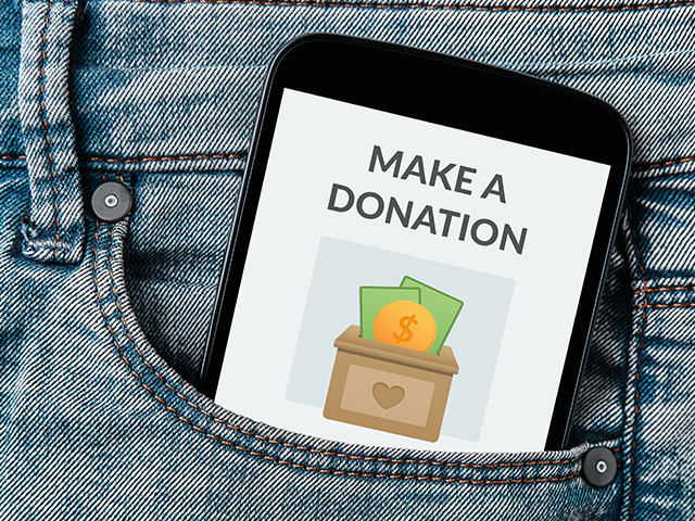 phone in jean pocket. on screen there is a "make a donation" button