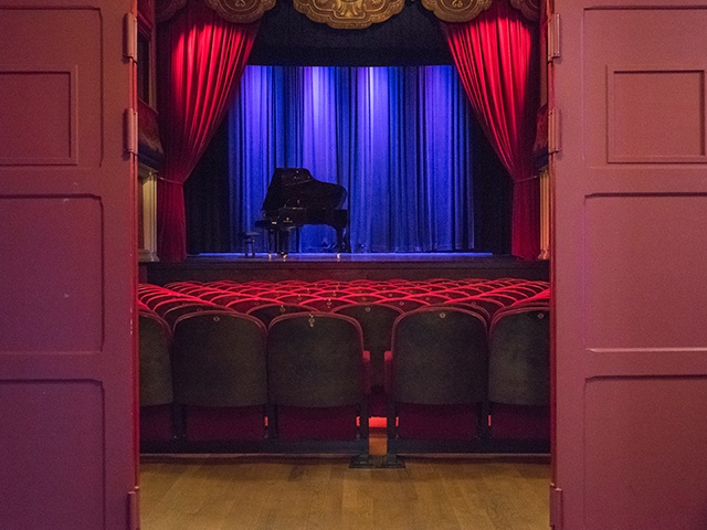 entrance to a theatre. piano on the stage