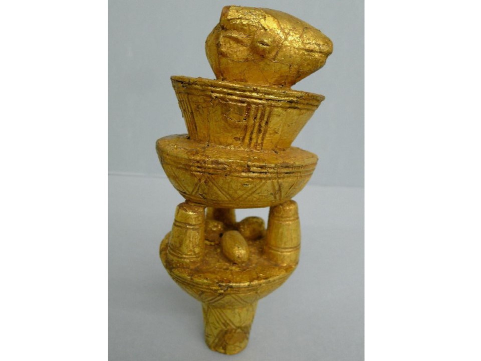 a gilded Asante umbrella finial carved with imagery